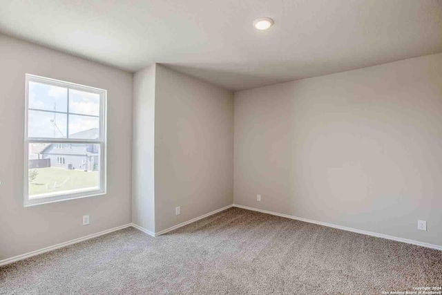 carpeted spare room with baseboards