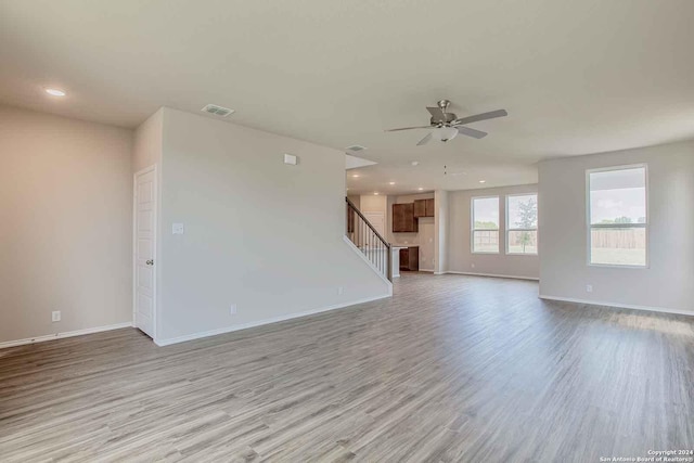 unfurnished room featuring a ceiling fan, recessed lighting, light wood-style flooring, and baseboards