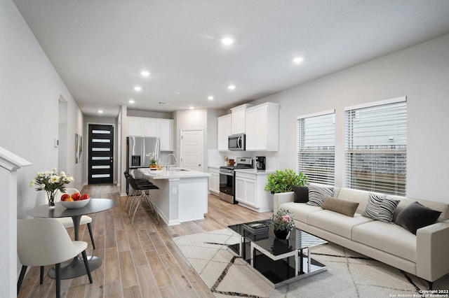 living room featuring light wood-style flooring and recessed lighting