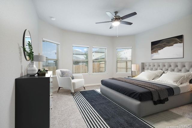 carpeted bedroom featuring a ceiling fan and baseboards