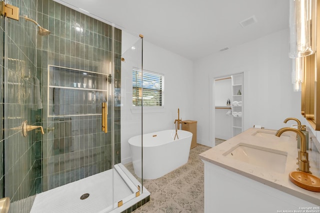 bathroom with a freestanding tub, a sink, visible vents, double vanity, and a stall shower