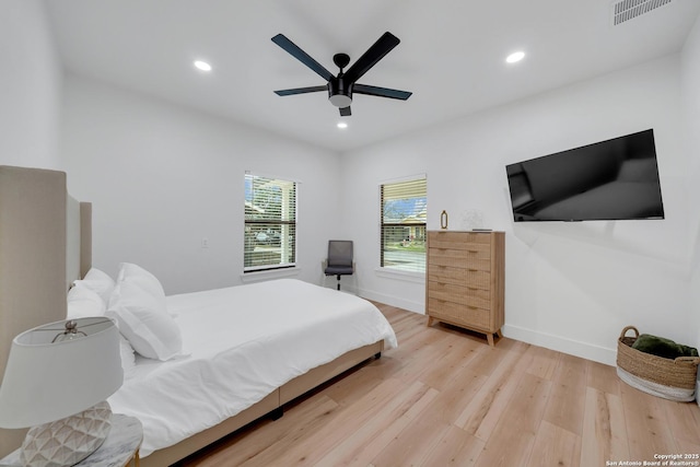 bedroom with light wood-style floors, baseboards, visible vents, and recessed lighting