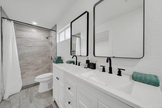 bathroom featuring marble finish floor, a sink, a tile shower, and toilet