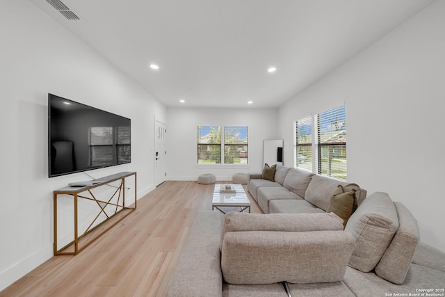 living area with light wood-style floors, baseboards, visible vents, and recessed lighting