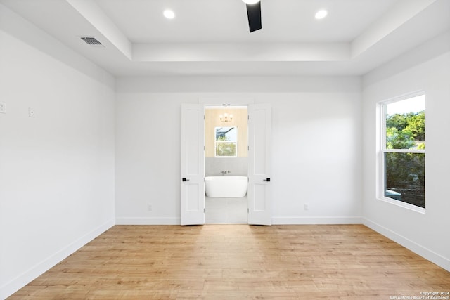 spare room featuring light wood finished floors, baseboards, visible vents, and recessed lighting