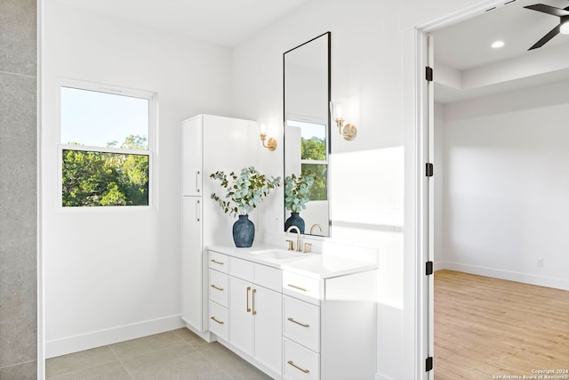 bathroom with recessed lighting, ceiling fan, vanity, and baseboards