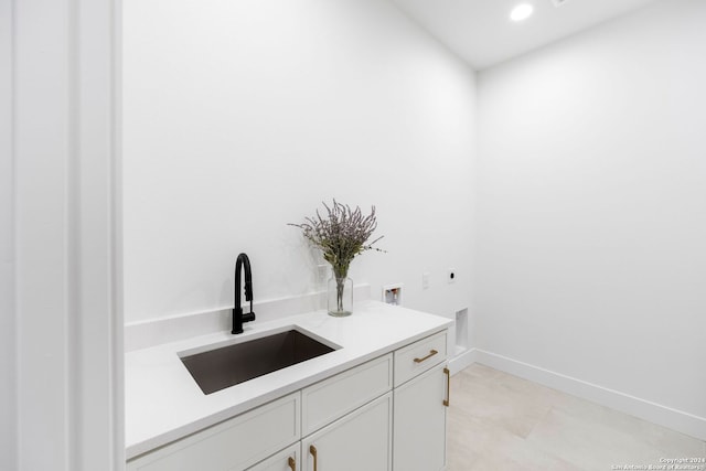 bathroom with recessed lighting, a sink, and baseboards