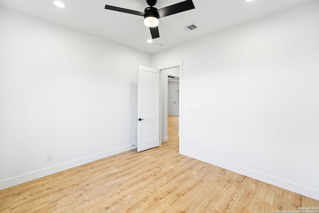 unfurnished room with ceiling fan, recessed lighting, wood finished floors, visible vents, and baseboards