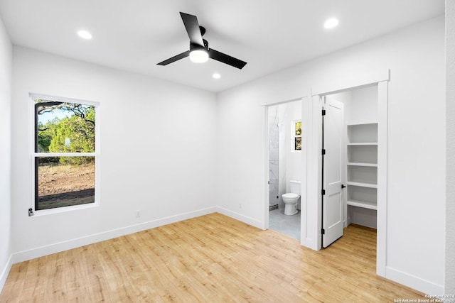 unfurnished bedroom featuring baseboards, light wood-type flooring, connected bathroom, and recessed lighting