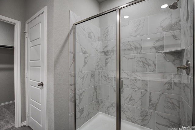 full bath featuring a textured wall, a stall shower, and recessed lighting