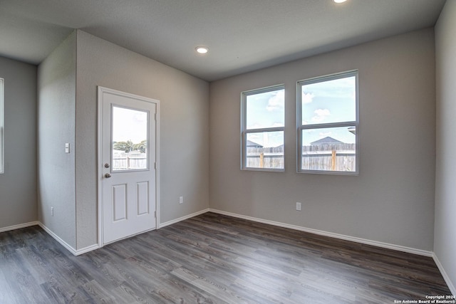 interior space featuring dark wood-style floors and baseboards