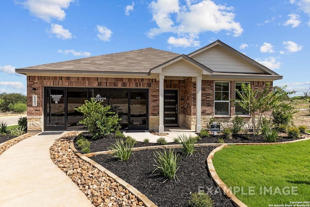 view of front of home with brick siding and a front yard