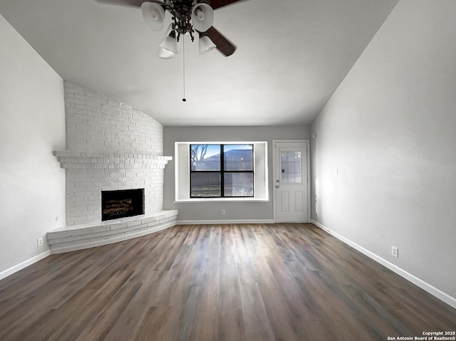 unfurnished living room featuring baseboards, a fireplace, a ceiling fan, and wood finished floors