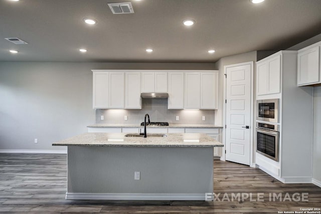 kitchen with stainless steel appliances, visible vents, white cabinets, a sink, and under cabinet range hood