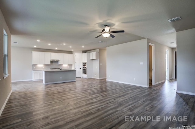 unfurnished living room featuring recessed lighting, a ceiling fan, visible vents, baseboards, and dark wood-style floors