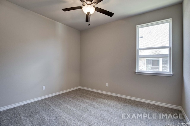 carpeted empty room with ceiling fan and baseboards