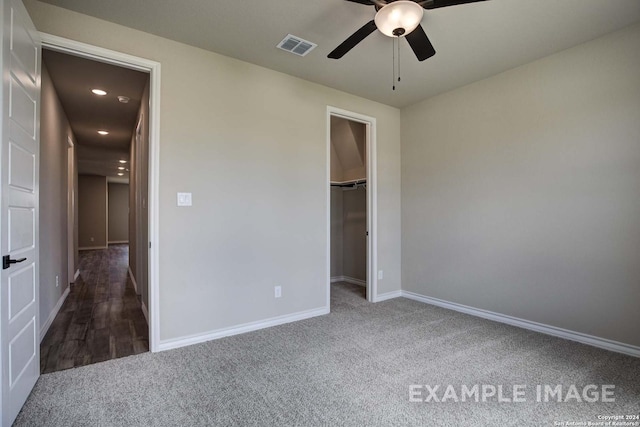 unfurnished bedroom featuring recessed lighting, carpet flooring, visible vents, baseboards, and a spacious closet