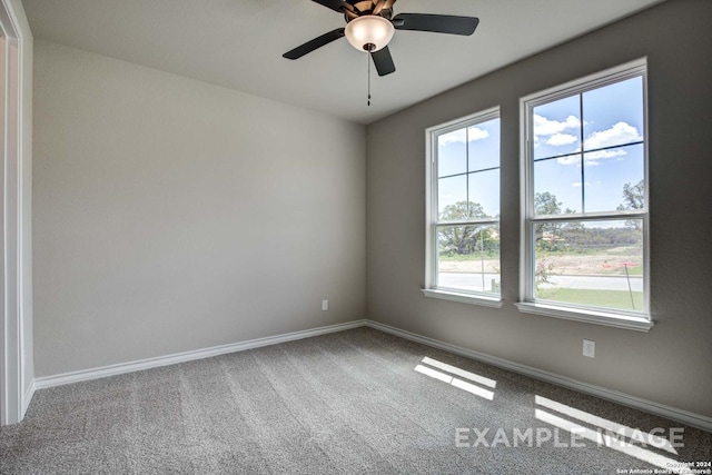 empty room with carpet floors, ceiling fan, and baseboards