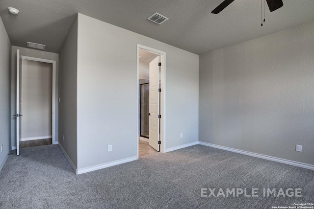 unfurnished bedroom featuring carpet floors, baseboards, visible vents, and a textured ceiling