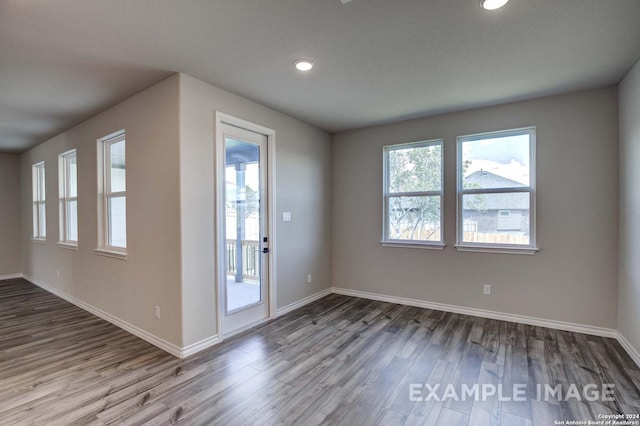 interior space with recessed lighting, baseboards, and wood finished floors