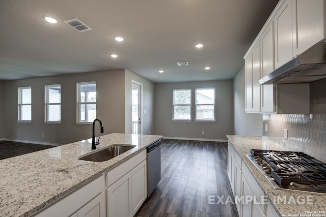 kitchen featuring white cabinets, visible vents, stainless steel appliances, and a sink