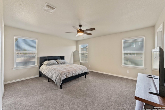 bedroom with visible vents, baseboards, a ceiling fan, carpet, and a textured ceiling