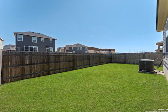 view of yard featuring central AC unit and a fenced backyard