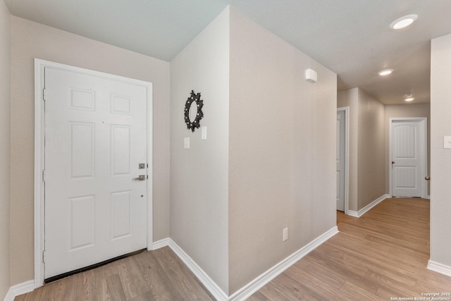 interior space with light wood finished floors and baseboards