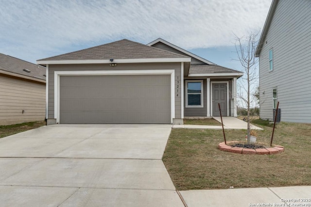 ranch-style home featuring driveway, roof with shingles, and an attached garage