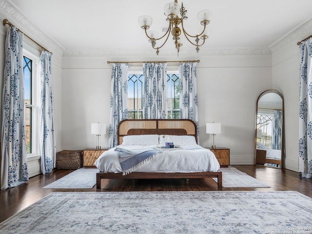 bedroom with multiple windows and wood finished floors