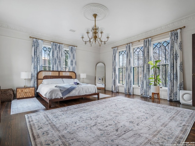 bedroom featuring a notable chandelier, dark wood-type flooring, and visible vents