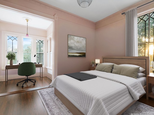 bedroom with dark wood finished floors, baseboards, and ornamental molding