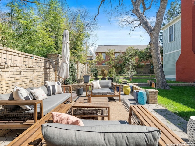 view of patio with outdoor lounge area and fence