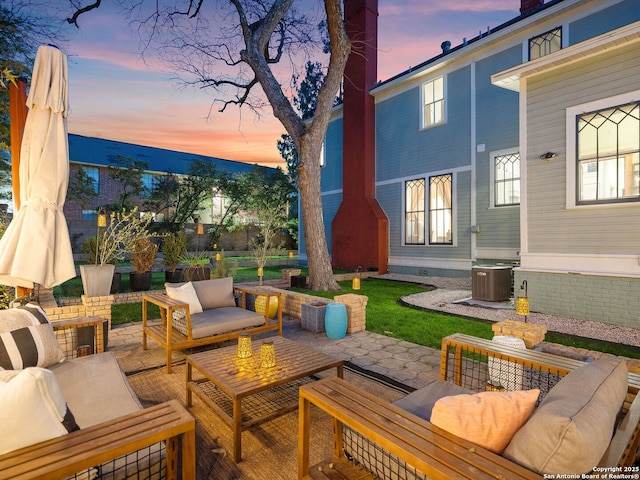 view of patio / terrace with an outdoor living space and central AC unit