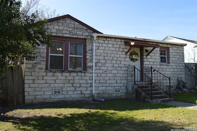 view of front facade with entry steps, crawl space, and a front lawn