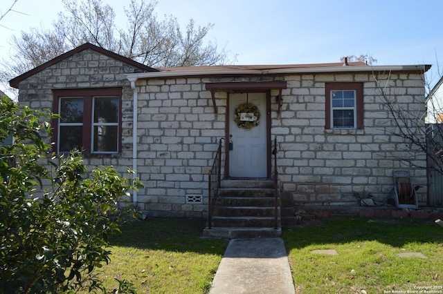 bungalow-style house featuring entry steps, crawl space, and a front yard