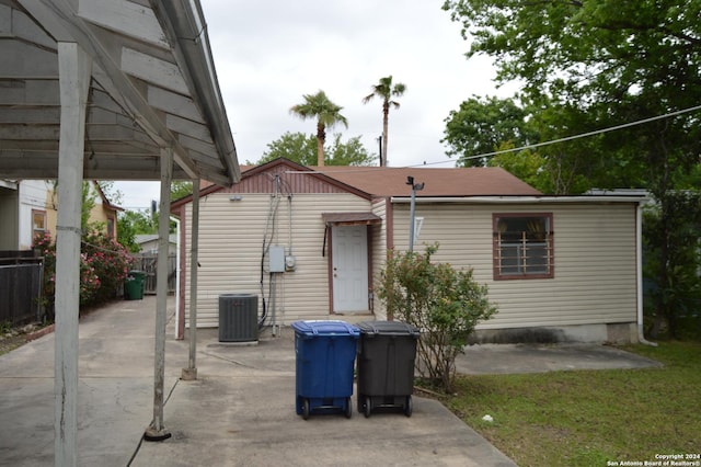 back of property with cooling unit, a patio, and fence