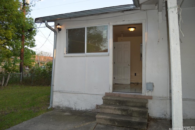view of exterior entry with fence