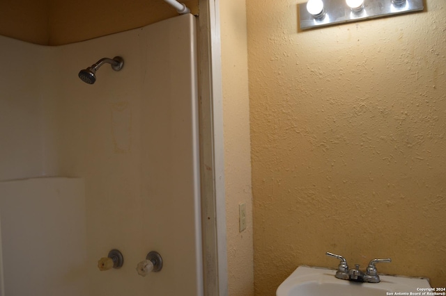 bathroom with walk in shower, a sink, and a bathing tub