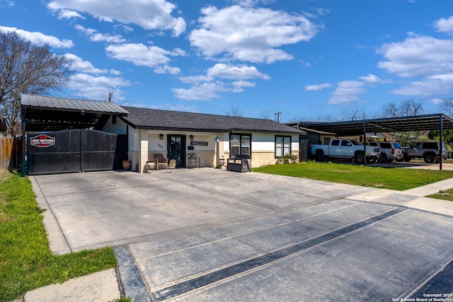 single story home with a front yard, fence, driveway, and a gate