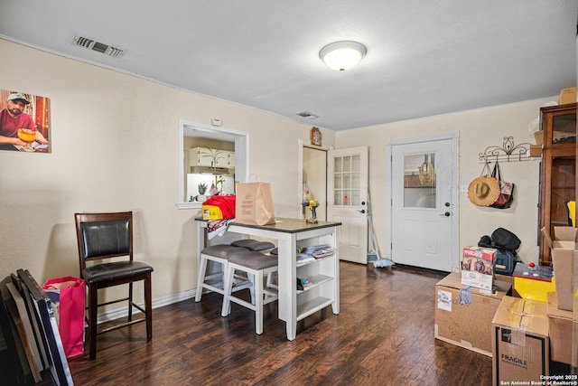 interior space featuring wood finished floors, visible vents, and baseboards