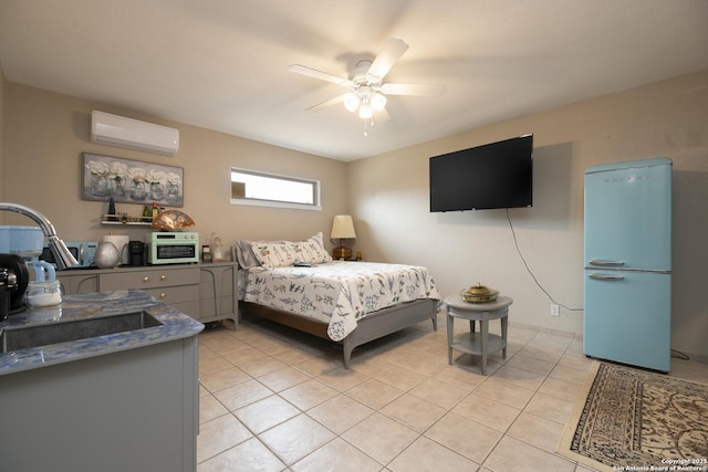 bedroom featuring an AC wall unit, light tile patterned floors, a sink, and fridge