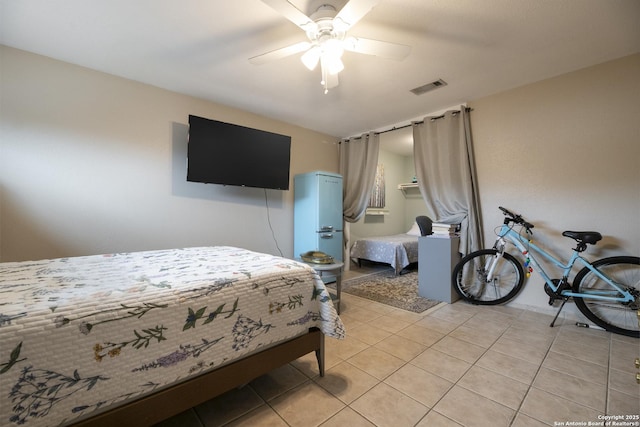 bedroom featuring light tile patterned floors, ceiling fan, and visible vents