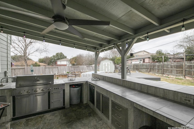 view of patio with a shed, a ceiling fan, a fenced backyard, and an outdoor structure