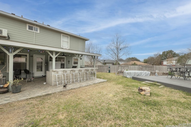 view of yard featuring a fenced in pool, a fenced backyard, a patio, and outdoor dry bar