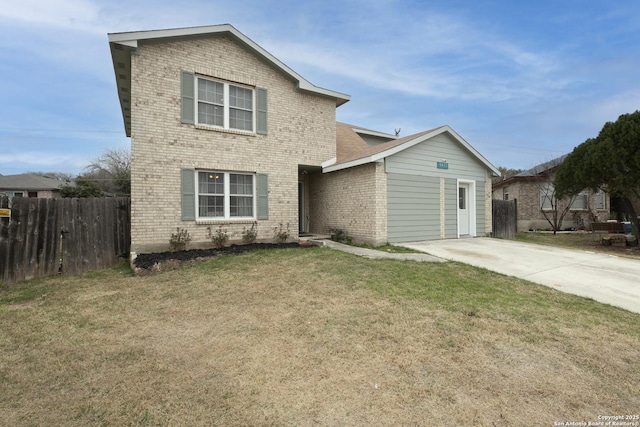 traditional-style house featuring driveway, brick siding, a front yard, and fence