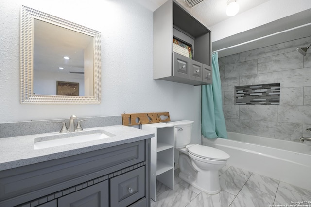 bathroom with marble finish floor, shower / tub combo with curtain, vanity, and toilet