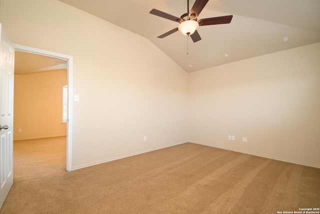 empty room with vaulted ceiling, baseboards, a ceiling fan, and light colored carpet