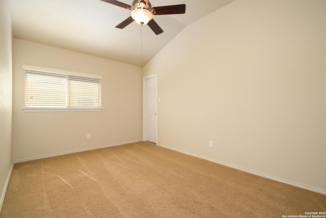 empty room with lofted ceiling, baseboards, a ceiling fan, and light colored carpet