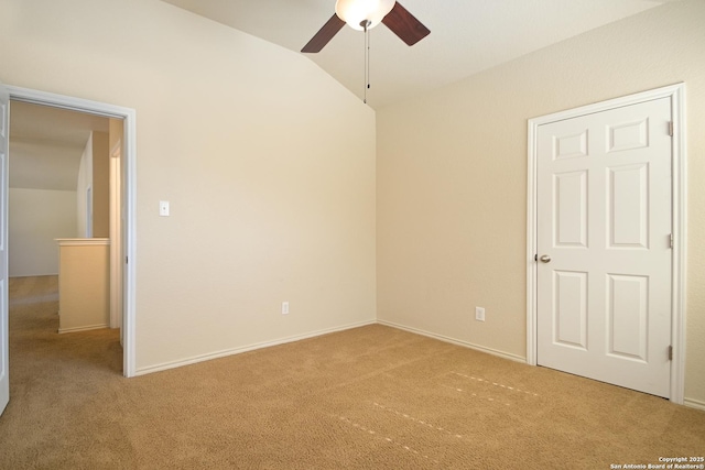 unfurnished bedroom featuring lofted ceiling, carpet floors, ceiling fan, and baseboards